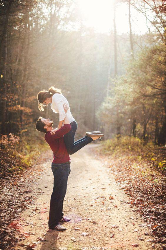 Boy holding girl in her arms in love