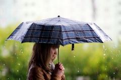 Girl holding umbrella rainy day