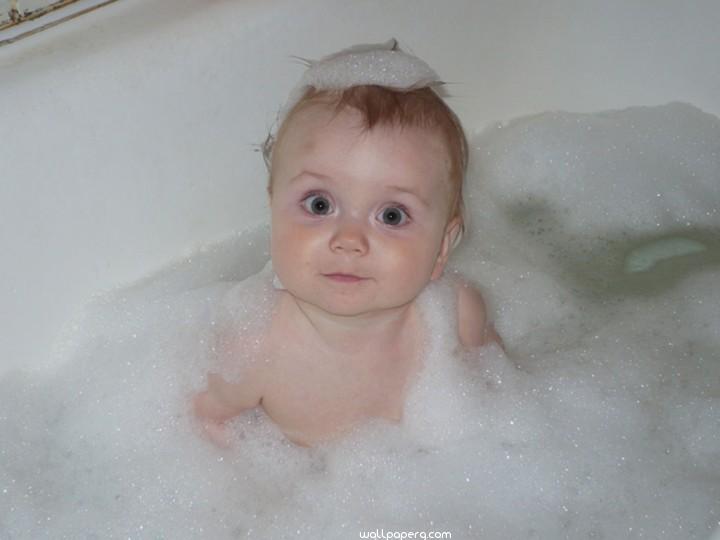 Baby playing in bath tub