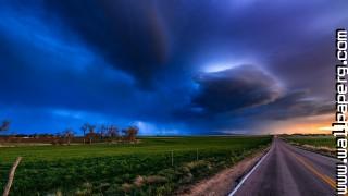 Rain clouds over a rural highway